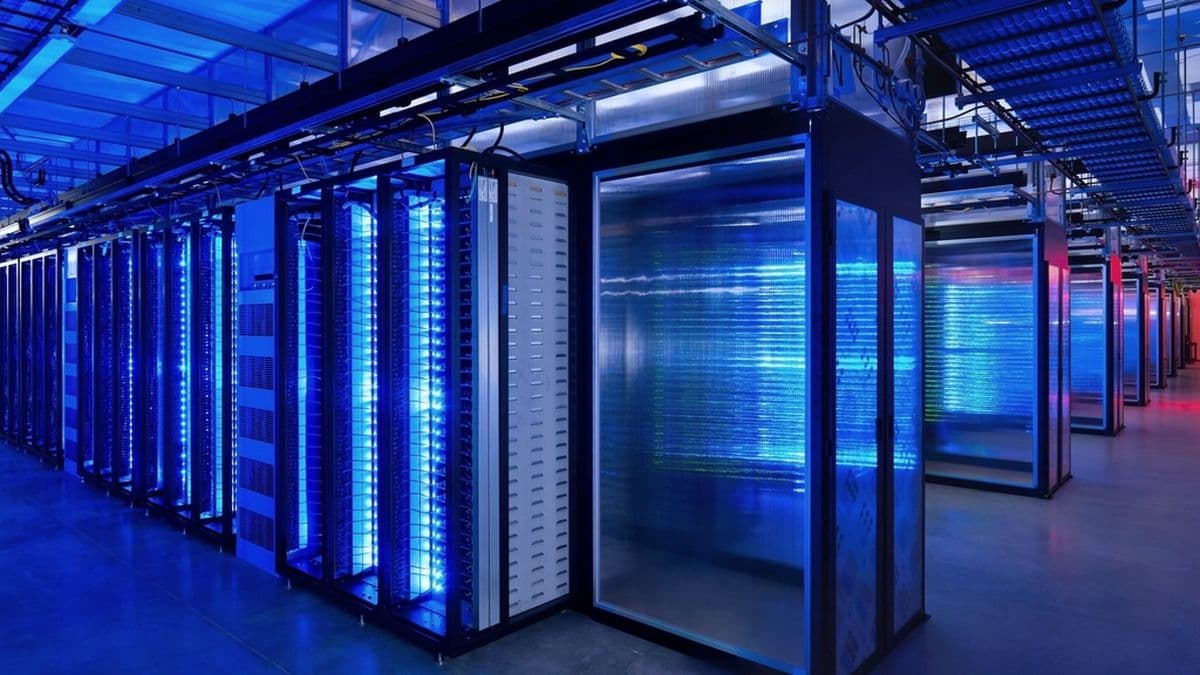 Rows of virtualised servers in a blue-lit equipment room