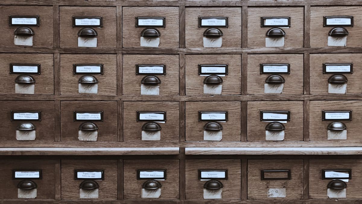 Wall of labelled index drawers representing an organised, retrievable document archive
