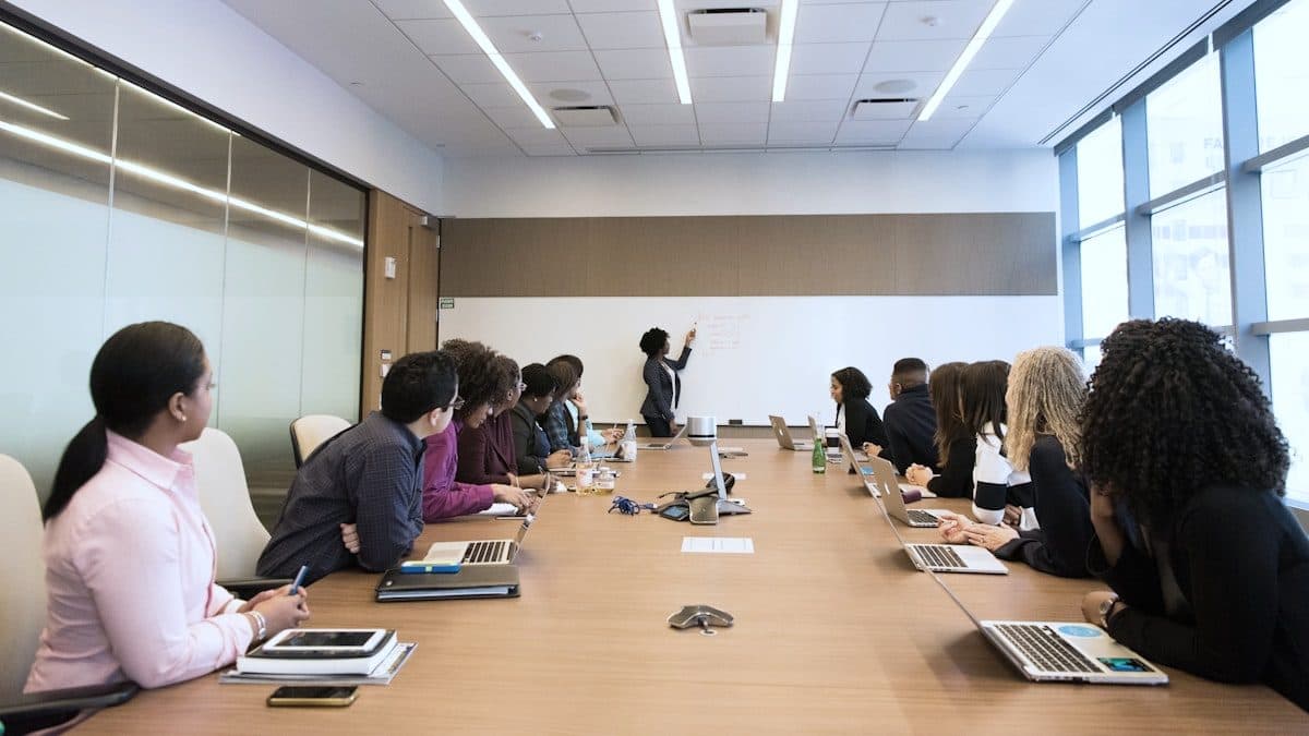Team seated around a boardroom table during a software training session