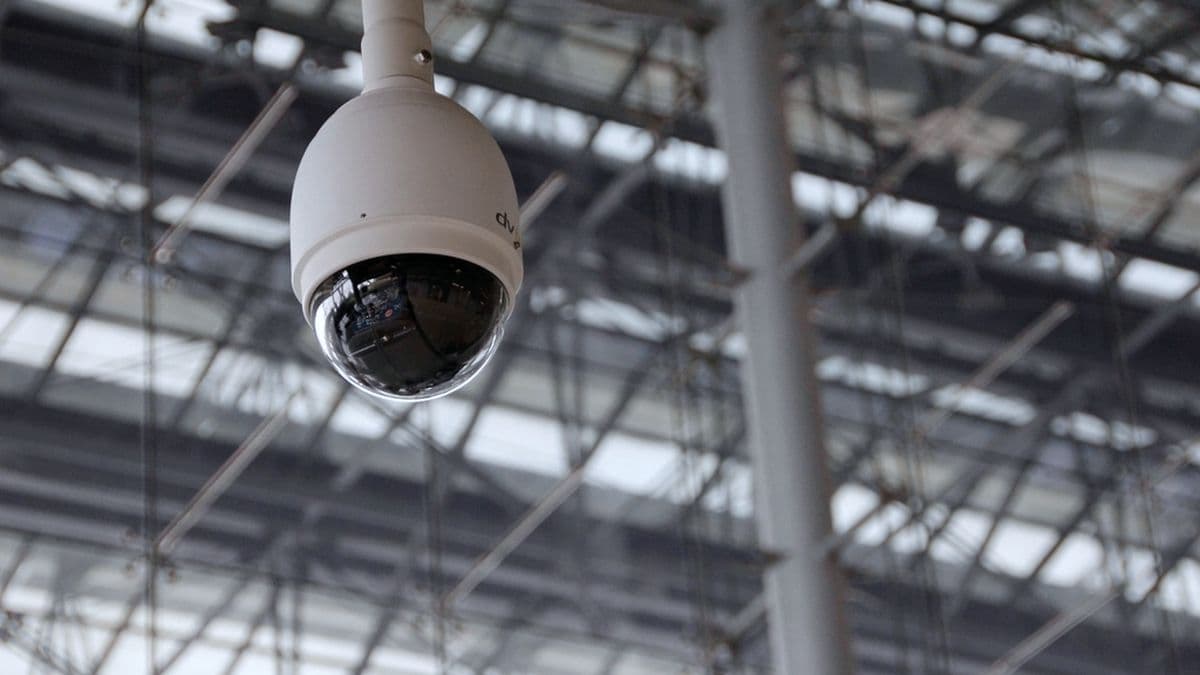Dome surveillance camera covering a wide industrial interior from the ceiling