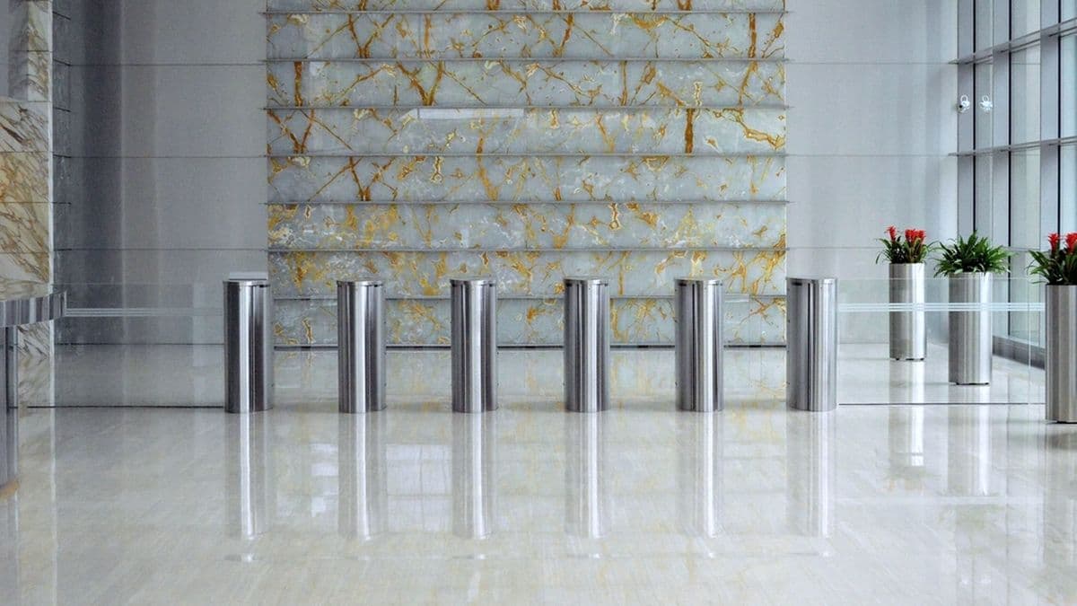 Speed gates controlling entry across a bright corporate lobby
