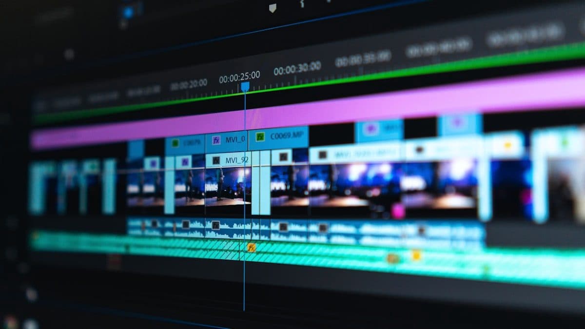 Video editing timeline of clips and audio tracks on a dark screen