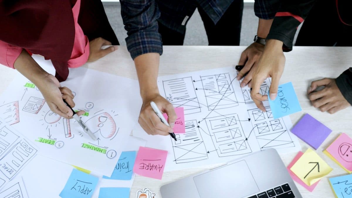 Team mapping out content layouts and campaign notes across a table