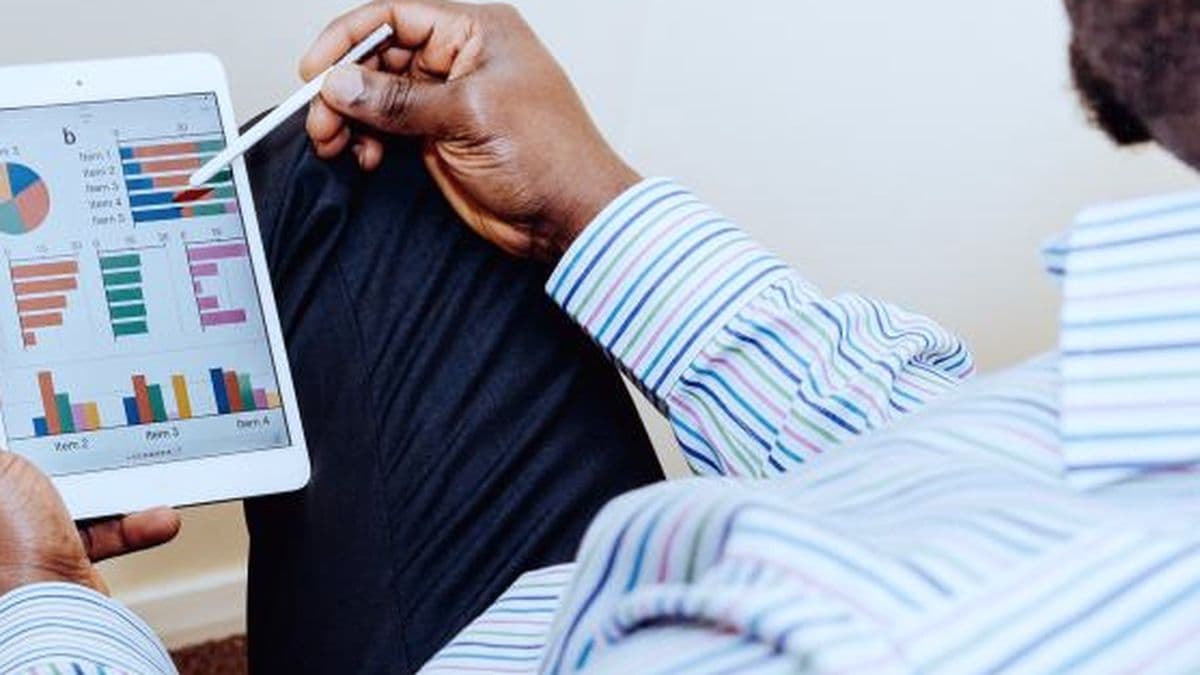 Consultant working through workload charts on a tablet with a stylus