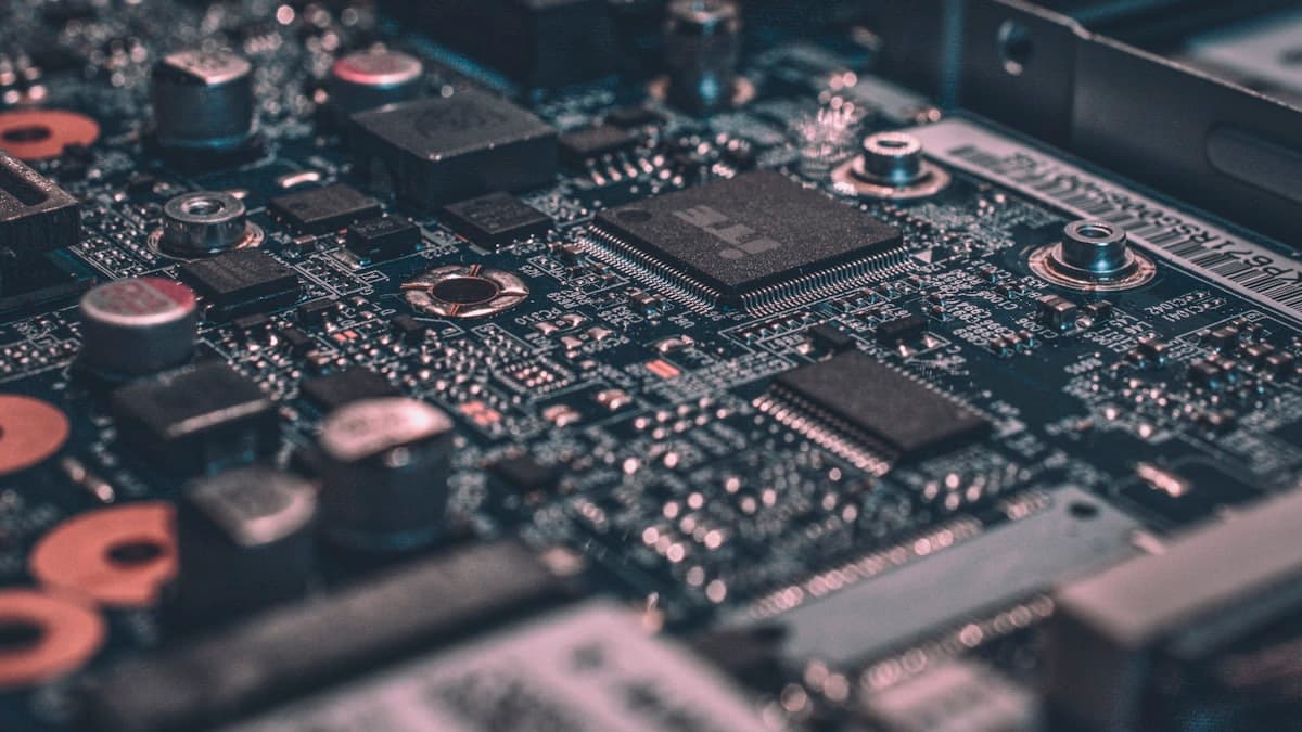 Close-up of a circuit board's processors and controllers under cool lighting