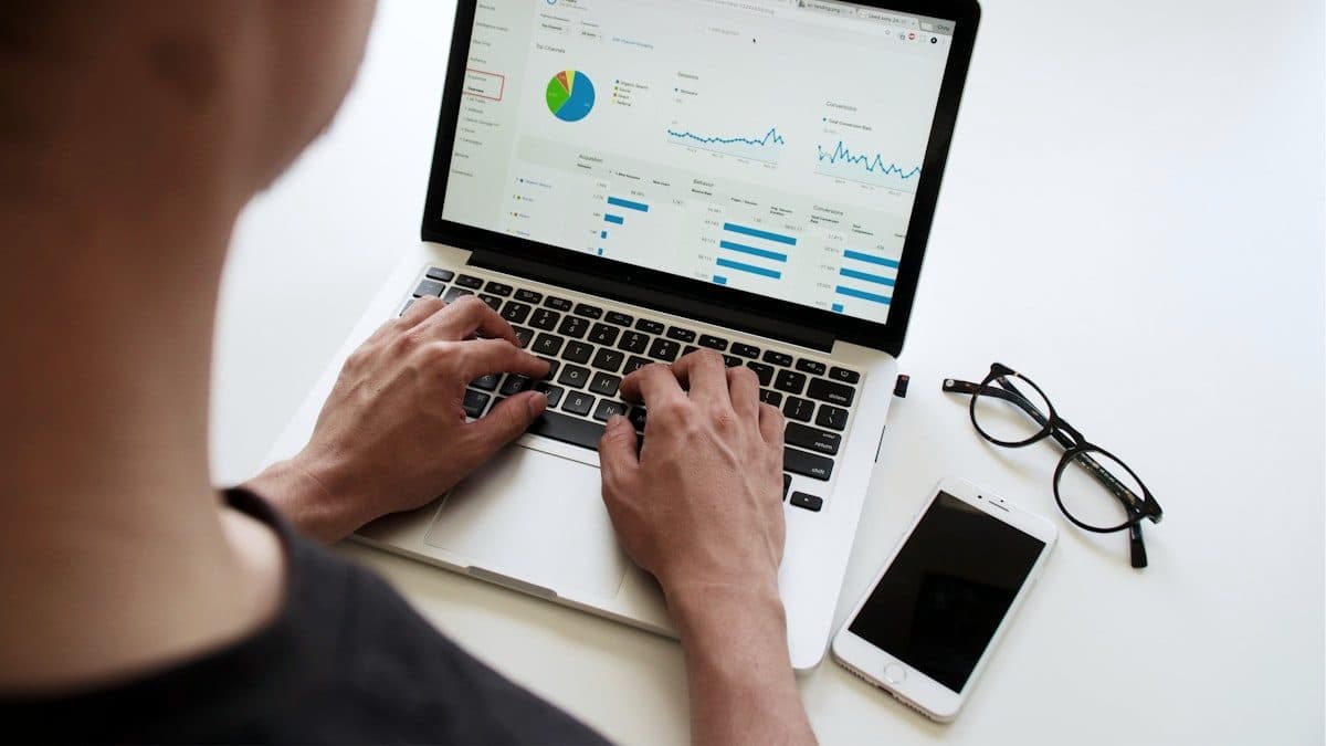 Laptop showing campaign performance charts and conversion metrics